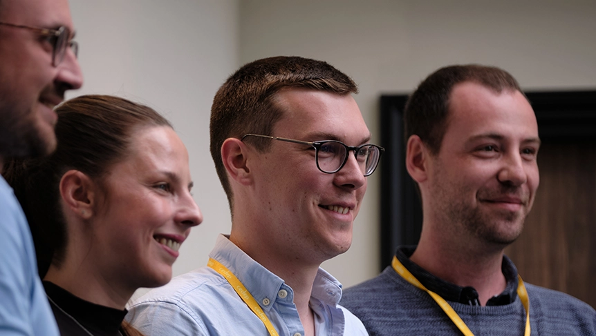 Group of diverse professionals sharing a lighthearted moment